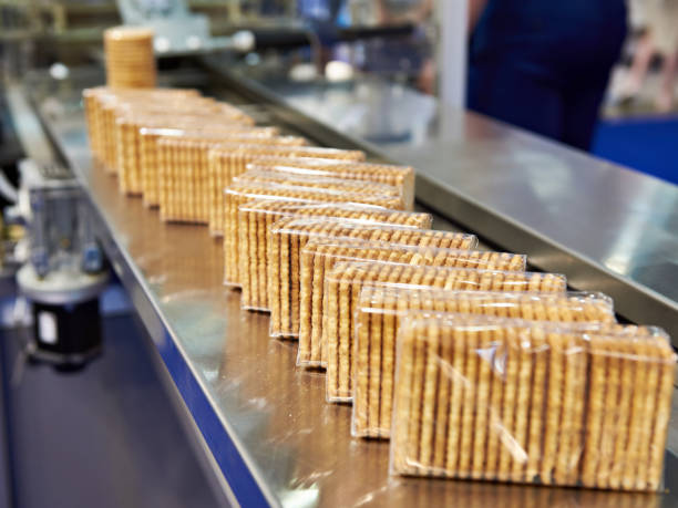 verpackung von cookies im werk - nahrungsmittelfabrik stock-fotos und bilder