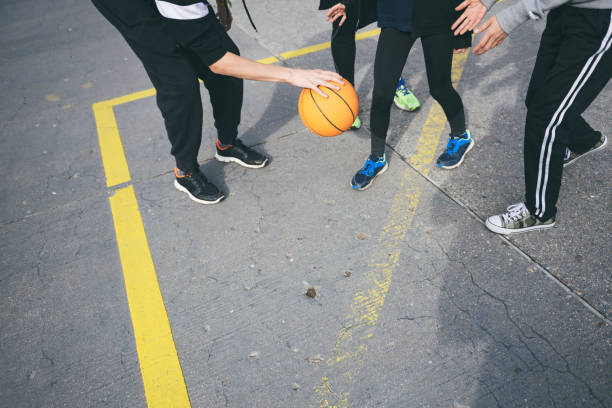 istock playing basketball on street together 987568454