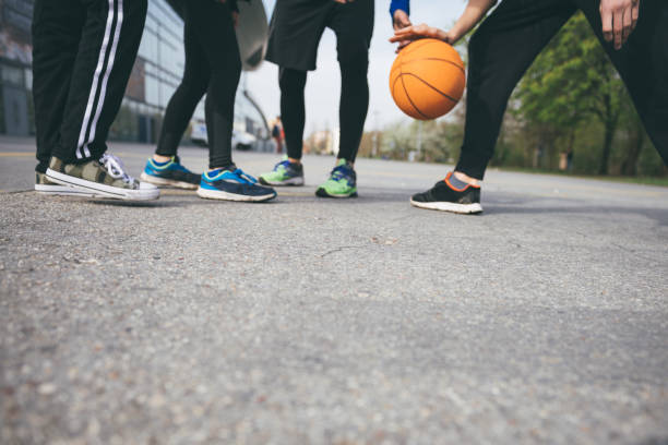 istock playing basketball on street together 987568594
