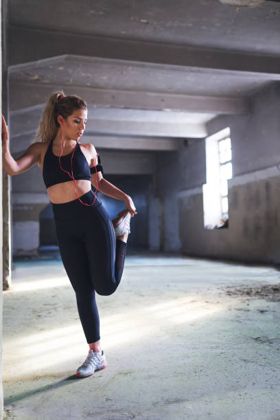 istock Handsome woman stretching legs 987572230