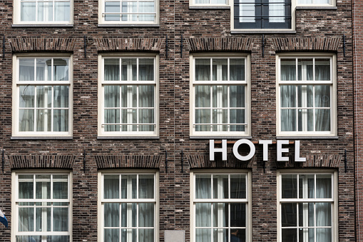 Hotel sign in exterior view on a brick wall