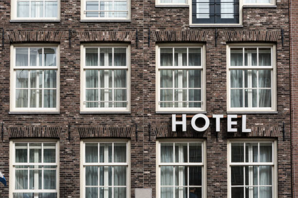 hotel sign in exterior view on a brick wall - built structure building exterior hotel old imagens e fotografias de stock