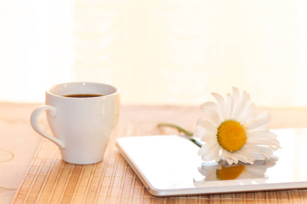 istock morning coffee and chamomile on the tablet, filter applied 987584776