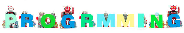 istock retro tin robot toys hold up the word  PROGRAMMING s 987602146
