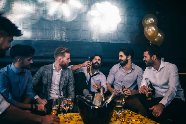 Night out with mates Group of young men drinking at a nightclub stag night stock pictures, royalty-free photos & images