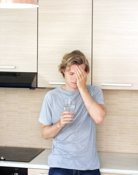 istock Teenager depressed  standing in the kitchen 987622422