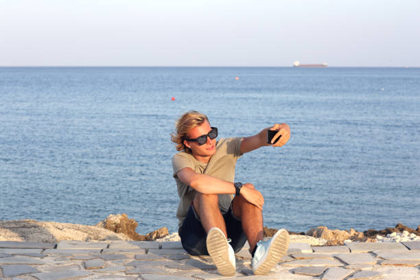 Teenage boy using smart phone.Selfie