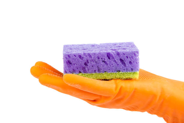 istock Hand in rubber glove with sponge on white. 987623046