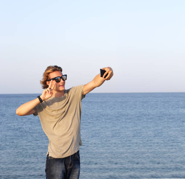 istock Teenage boy using smart phone.Selfie 987623050