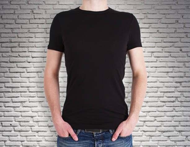 istock Man wearing black shirt on brick background 987624582