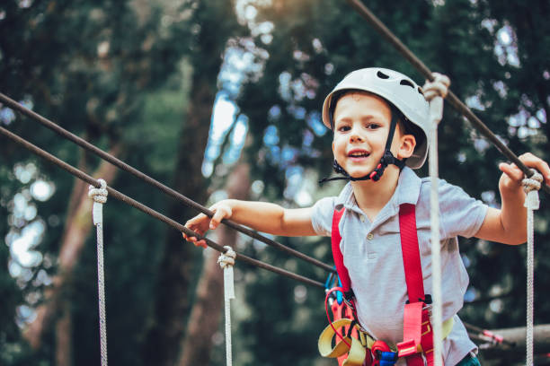 istock Happy boys playing at adventure park on sunny day. 987632604