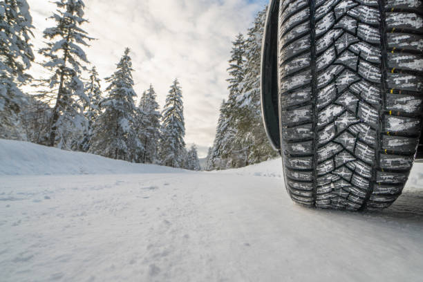 istock car with winter tires on snowy road 987648506