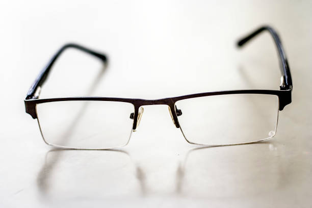 istock Half rim black colored framed spectacles or reading glasses isolated on white. 987648690