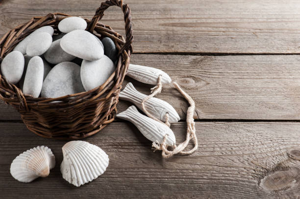 istock Shells and pebbles on wooden background 987649156