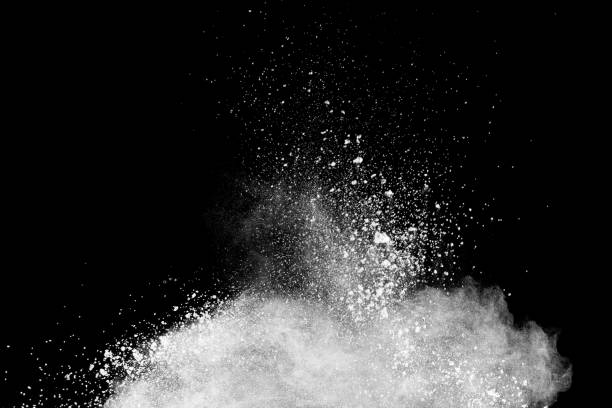 istock Launched white powder splash on black background. Bizarre forms of of white powder explosion cloud against dark background. 987649250