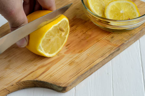 istock Someone cutting a lemon on the chopping board. 987655754