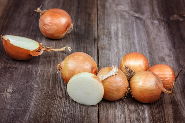 istock Fresh onions on a wooden background 987662470