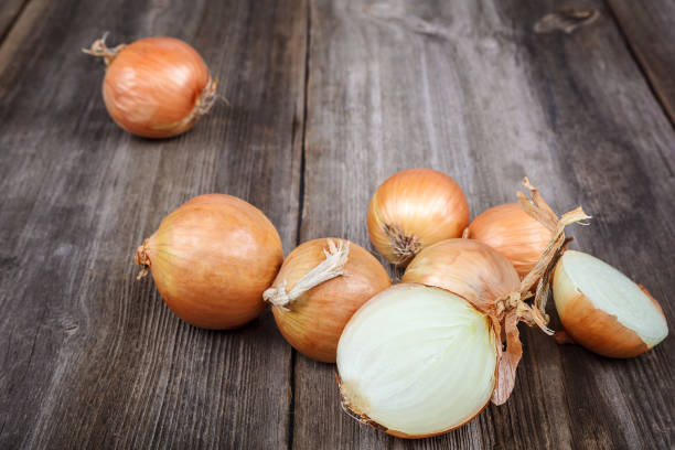 istock Fresh onions on a wooden background 987666720