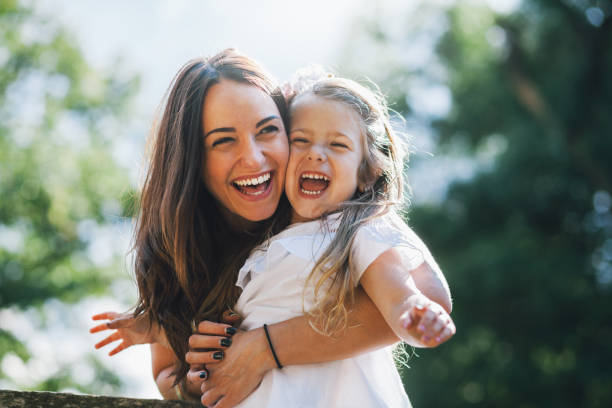 istock Playful  mom and daughter in the park 987669502