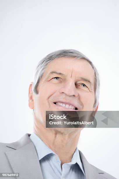 Closeupconfident Senior Businessman Looking Up At Copy Space Stock Photo - Download Image Now