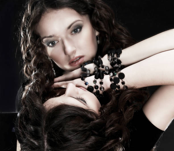 istock glamorous beautiful woman looking at her reflection 987676684