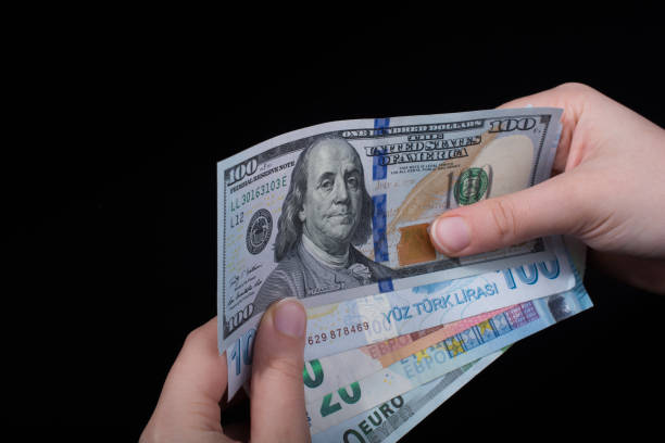 istock Hand holding American dollar  isolated on black background 987681406