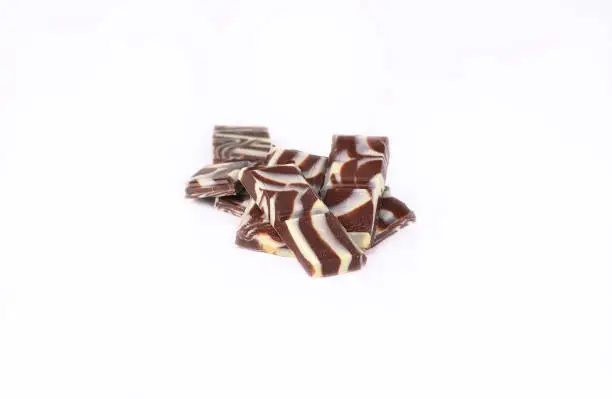 Photo of slices of original black and white chocolate.isolated on white