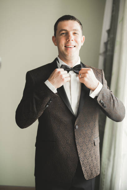 istock Beautiful man, groom posing and preparing for wedding 987699364