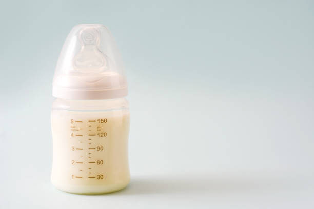 istock Baby bottle and milk 987708740