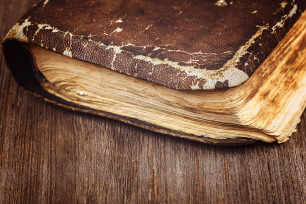 istock Ancient holy book on a cord on a wooden background 987720348