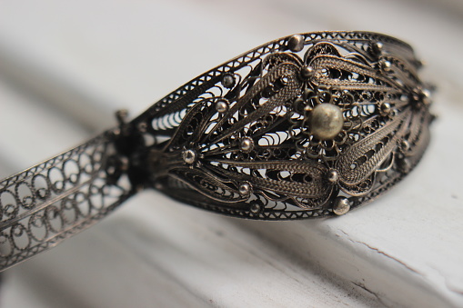Macro of a rustic silver filigree bracelet