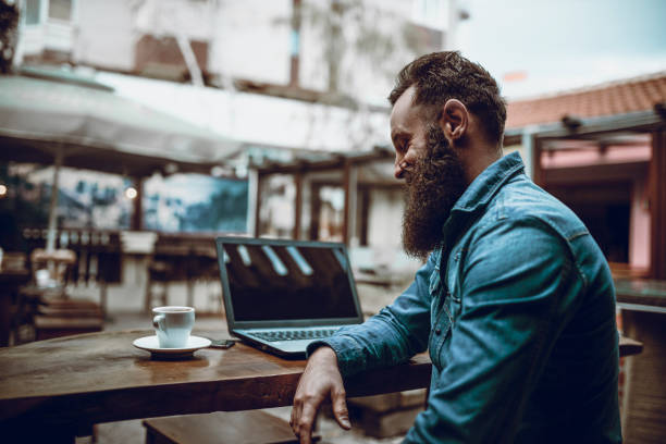 Successful Freelancer Enjoying Coffee And Working From Restaurant