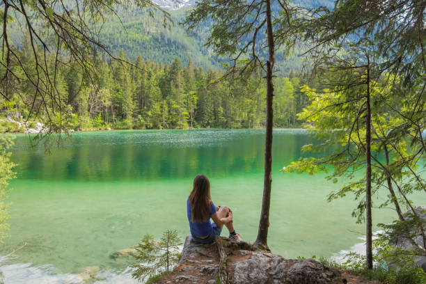istock MOther and daughter sitting on a lake 987739402