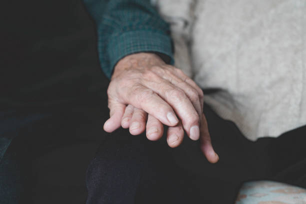 istock old man and old woman holding hands 987743918