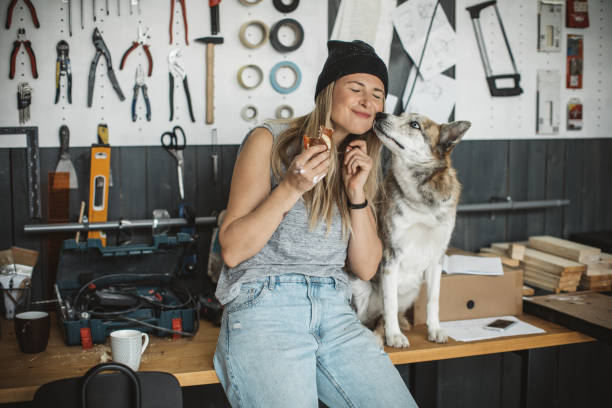 Women in workshop with her pet dog