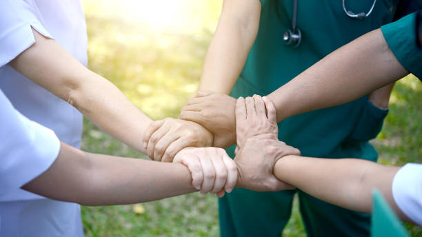 Doctors surgeon and nurses in a medical stacking hands. Doctors surgeon and nurses in a medical stacking hands teamwork. stacked hands photos stock pictures, royalty-free photos & images