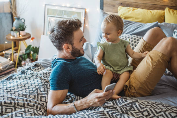 istock Father shows little daughter something on phone 987750768