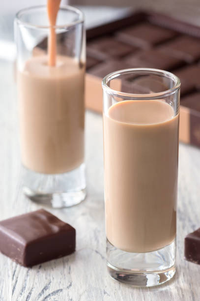 istock Coffee liqueur in a glass with chocolate sweets. 987754556