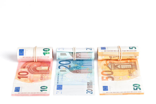istock Euro bills rolled up and isolated on white 987770162