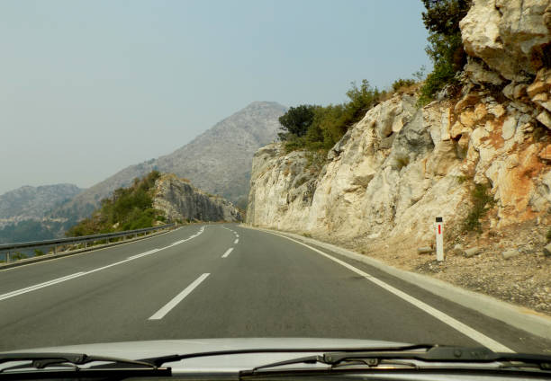 istock View through windshield on the double bend winding road in the mountains 987781434