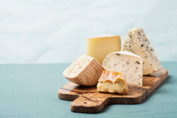 Variety of cheeses on serving board Cheese board: variety of cheeses on marble serving board ewe stock pictures, royalty-free photos & images