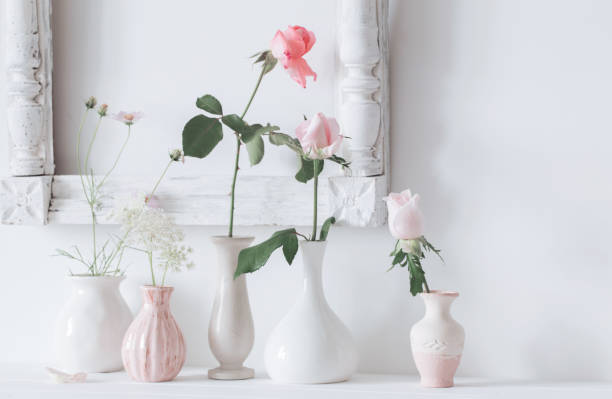 istock still life with pink roses in vase on white background 987788524