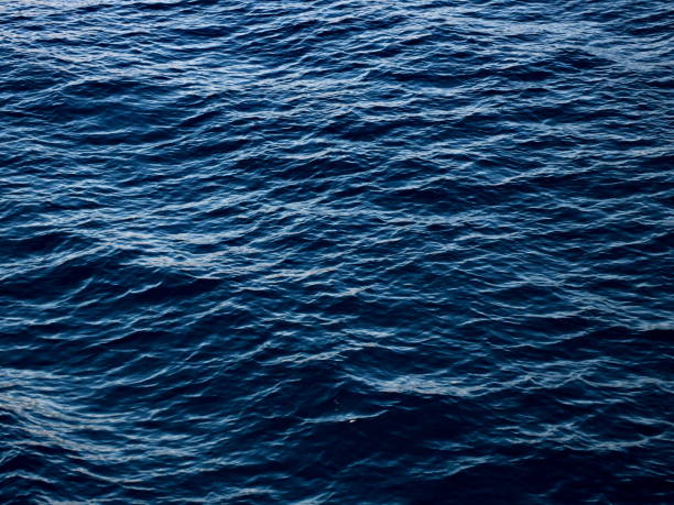 istock Blue sea water surface with small waves , motion blur 987789462
