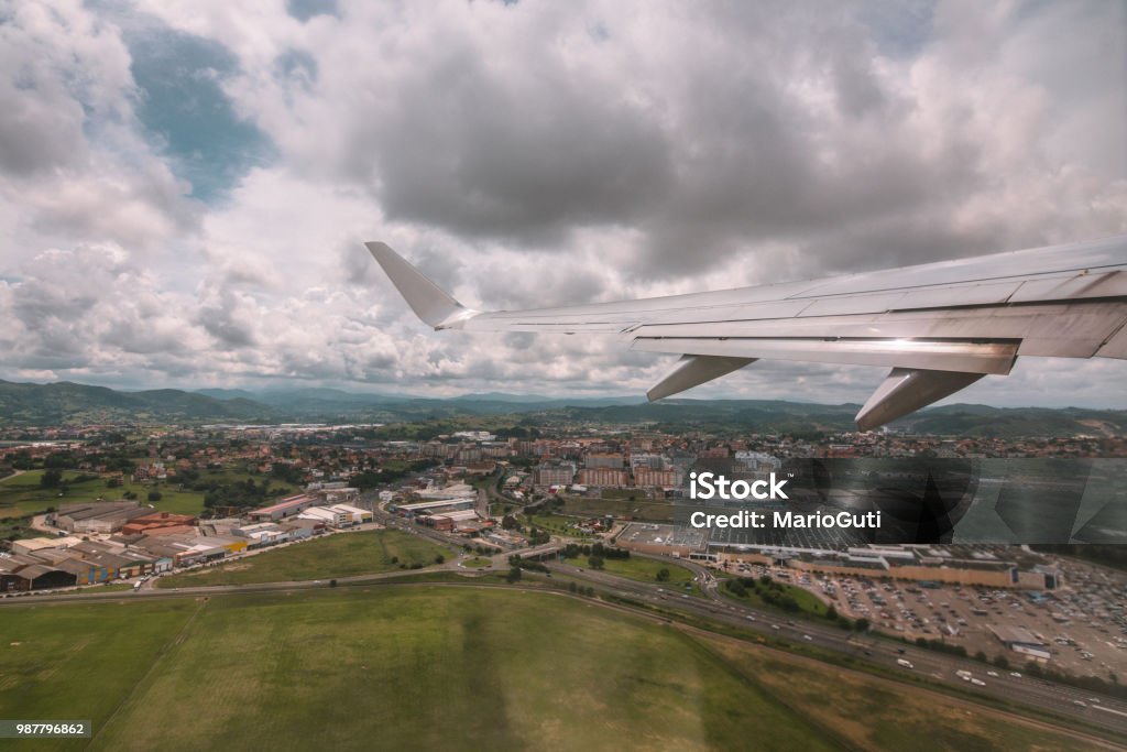 Airplane wing An airplane wing with a beautiful landscape below Aerial View Stock Photo