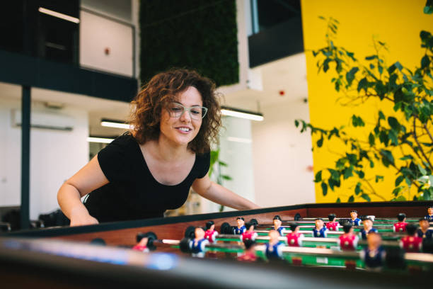 Happy young women playing table football