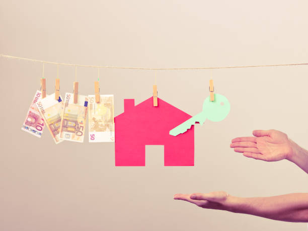 istock Male hands showing house and money 987797292