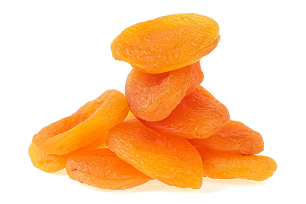 istock Heap of dried apricots on a white background 987805294