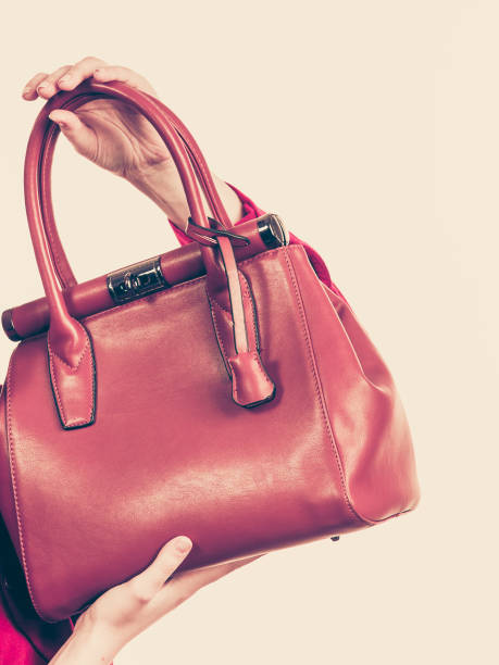 istock Female holding brown leather bag 987827080