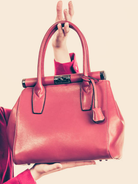 istock Female holding brown leather bag 987827830