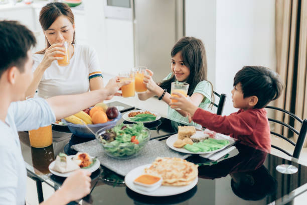 istock Family celebratory toast with fresh juice 987892512